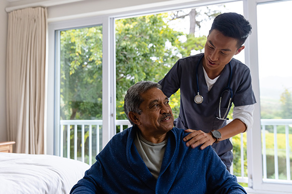 caregiver assisting elderly man in cozy room nurturing environment comfort and support 4 caregivers 4 elderly care