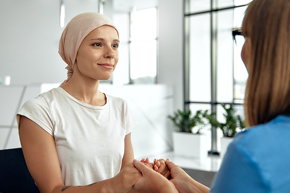 woman with a headscarf smiling during a supportive conversation in a bright modern space offering hope and connection in eight ways