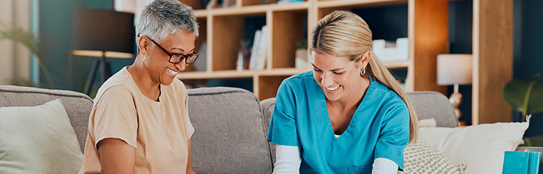 two women engaging in conversation one wearing glasses smiling the other in scrubs sharing a moment focused on building trust and connection in a healthcare setting four essential components of care
