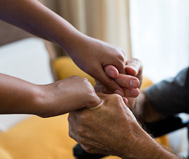 two hands gripping a third hand showcasing connection strength and trust 5 generations of bonding