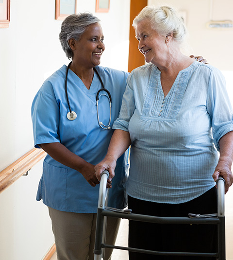 caregiver assisting elderly woman with walker in hospital setting supportive interaction health care 3 elderly care