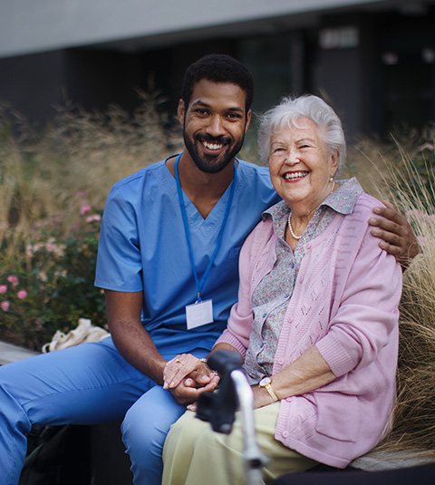 smiling nurse with elderly woman enjoying outdoor time together in a caregiving setting showcasing healthy aging and compassion 5 tips for elder care
