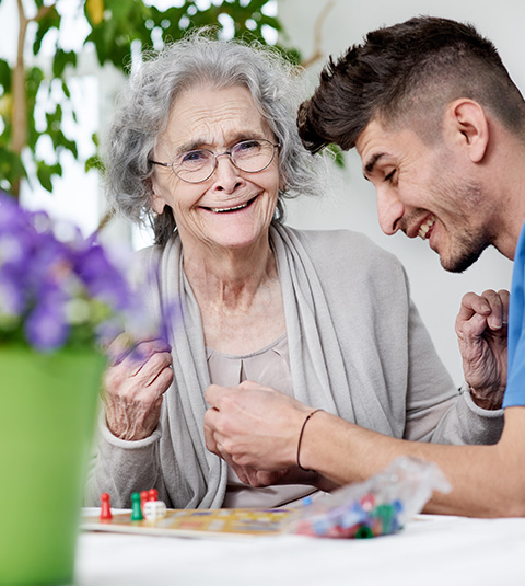 woman and man playing a board game in a bright room enjoying quality time together with joy and fun five meaningful moments