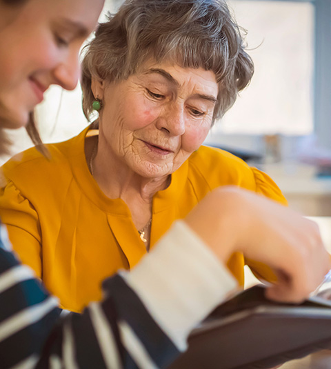 two people enjoying quality time together looking at a photo album connection between generations memories and moments shared 5 ways to connect