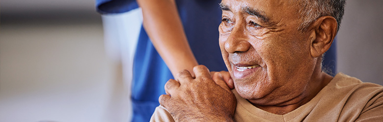 smiling elderly man with a hand on his shoulder warm connection support and care in five meaningful moments