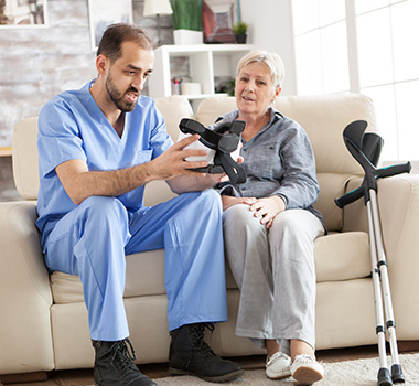 healthcare professional demonstrating device to patient in home setting with crutches nearby assisting recovery journey 3 tips