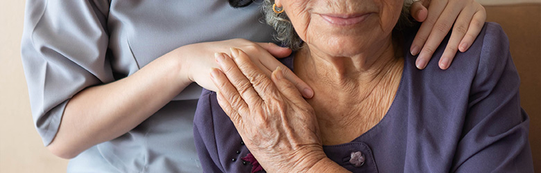 young woman gently embracing elderly woman with affection and warmth in a caring moment of connection